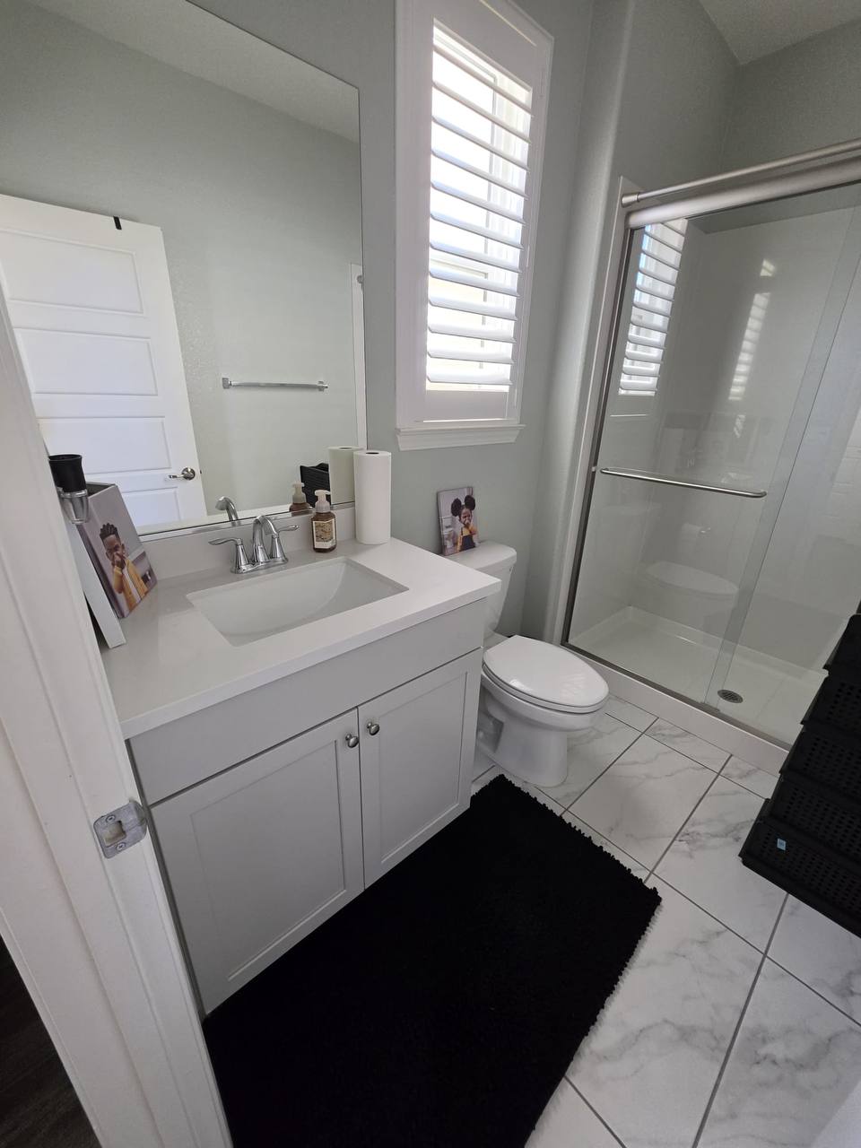 Clean bathroom vanity and shower from customer photo