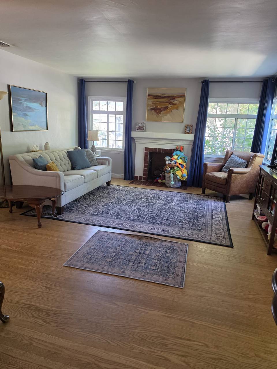 Clean living room with sofa and fireplace